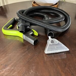 Karcher Puzzi upholstery nozzle with handle and hose.